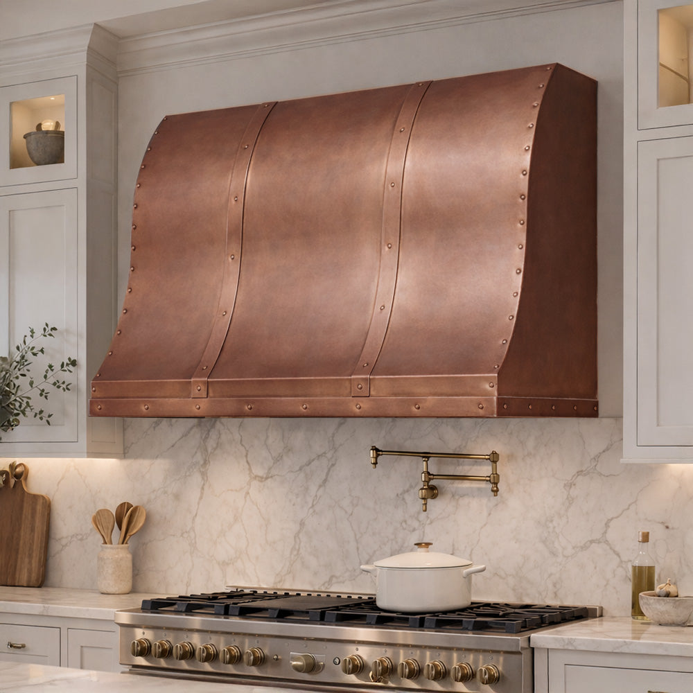 high end copper range hood with marble backsplash