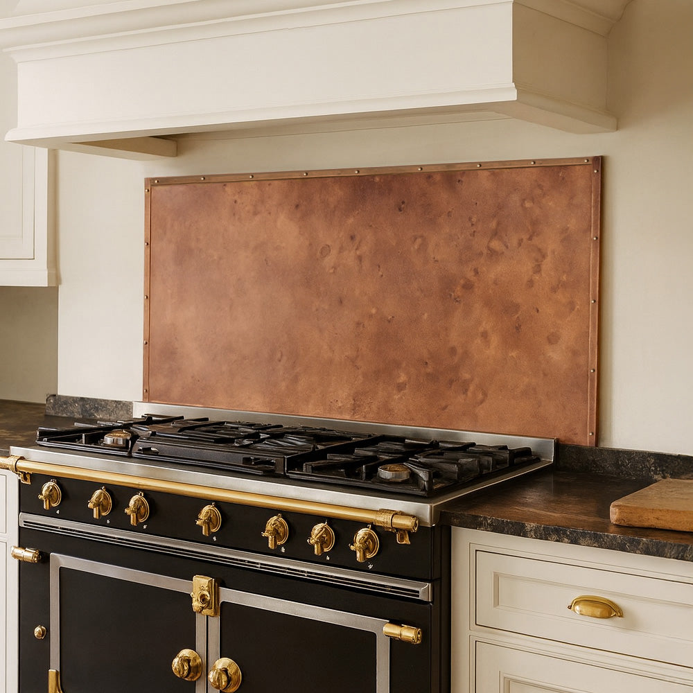 Copper stove backsplash panel designed for protection and visual impact.