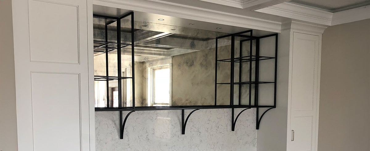statement shelf made of blackened steel and a mirror back
