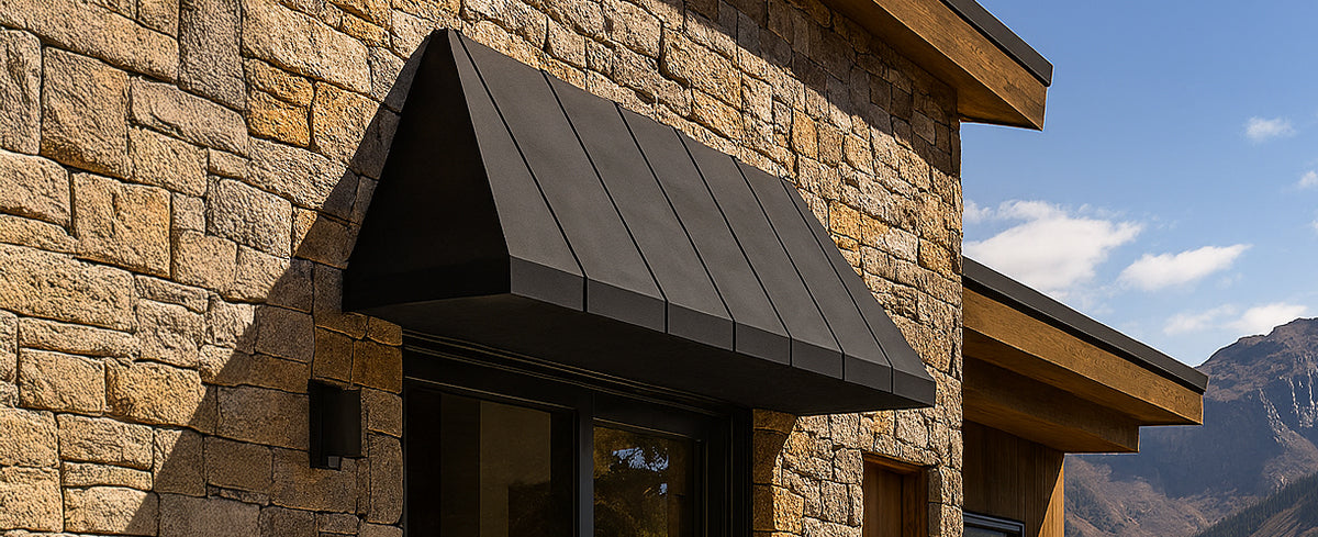 Handcrafted custom metal window awning installed above residential door.