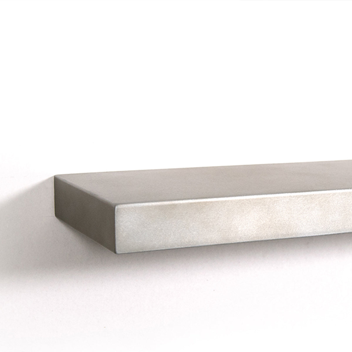 detail shot of antique zinc floating shelf on a white wall