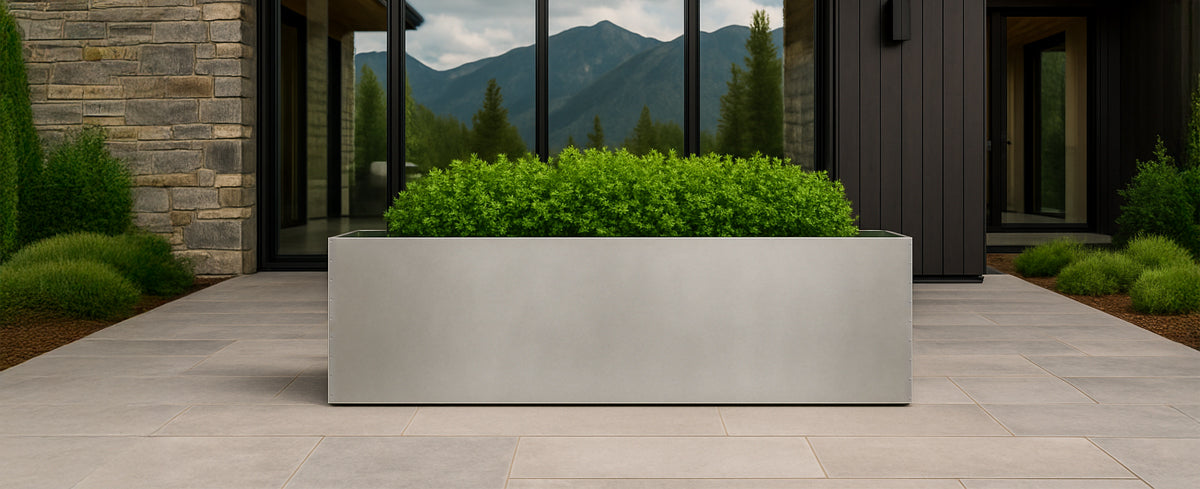 Large stainless steel planter used for outdoor landscaping and garden design.