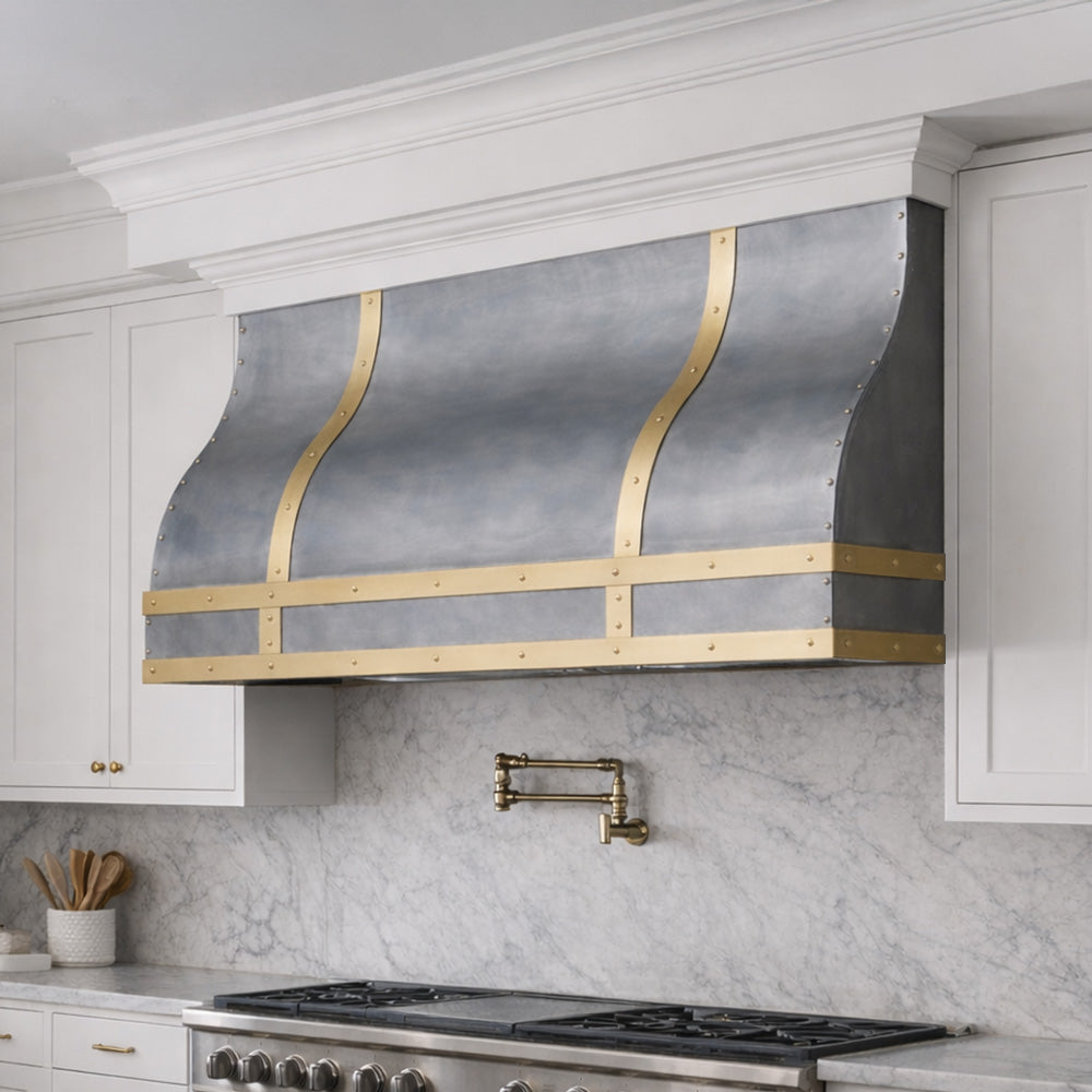 curved range hood in stainless steel with brass trim