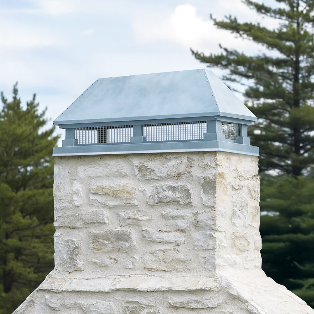 Zinc chimney cap on stone chimney