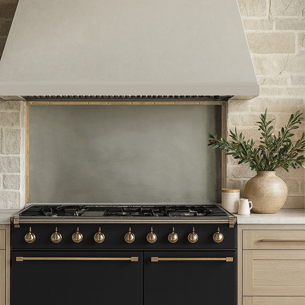 Handcrafted zinc backsplash installed behind kitchen range.